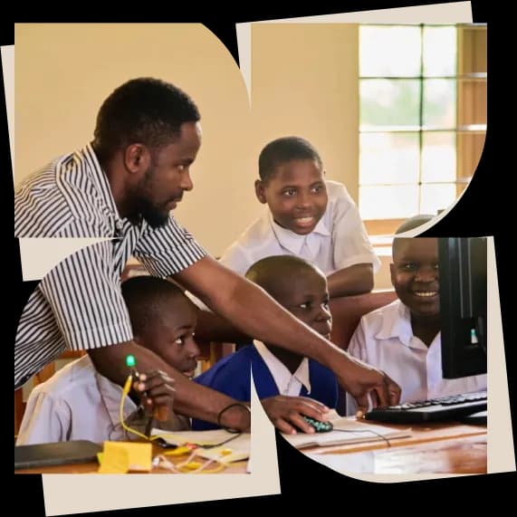 A Jenga facilitator helping students at a computer